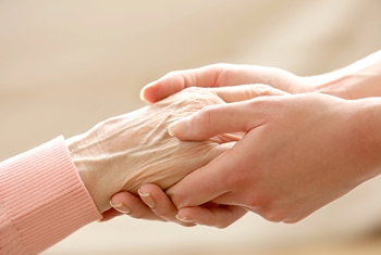 young hand holding elderly hand showing care for senior hygiene and adult diapers